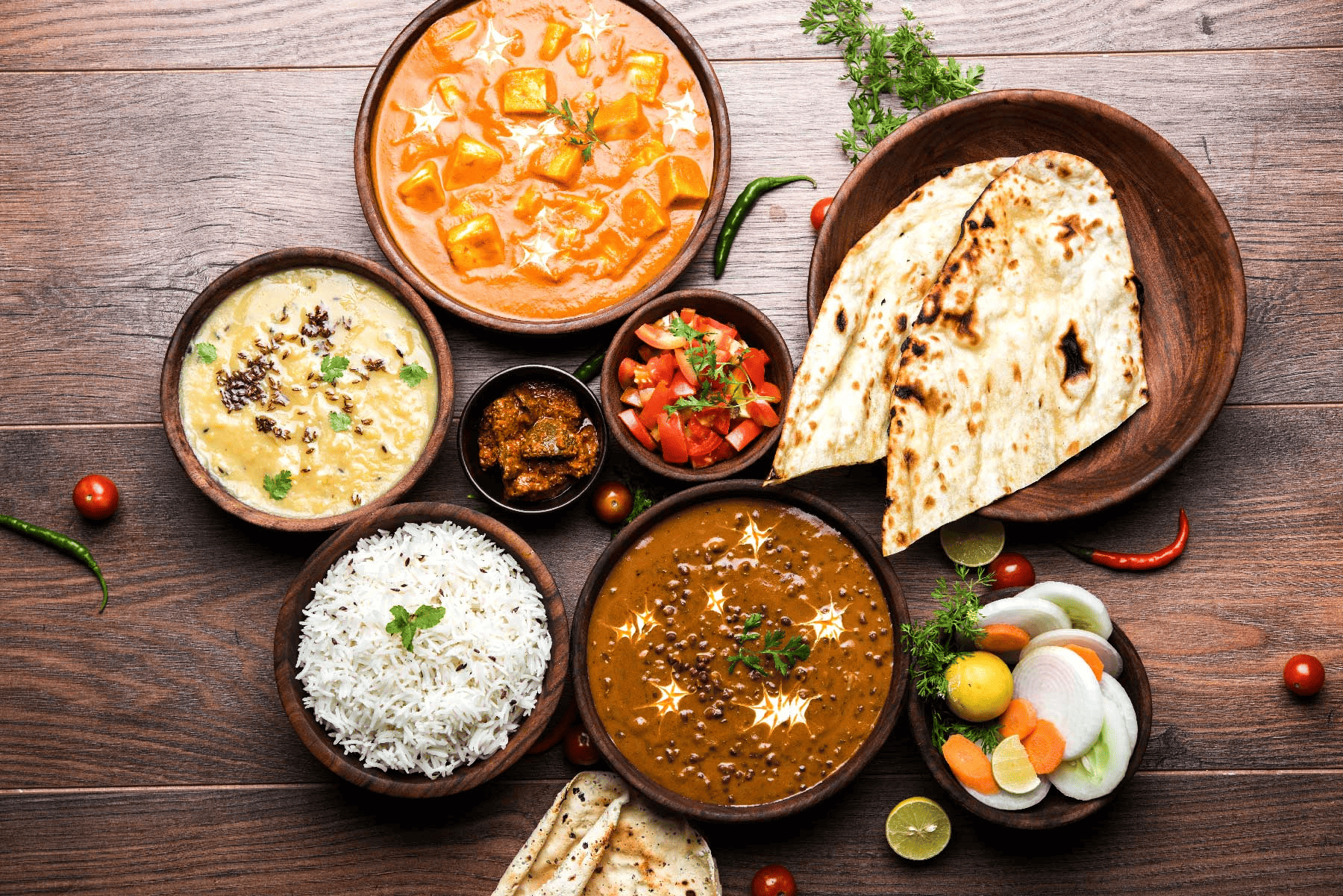 Delicious spread of Vegetarian Indian food with rice, salads, curries and daal makhni