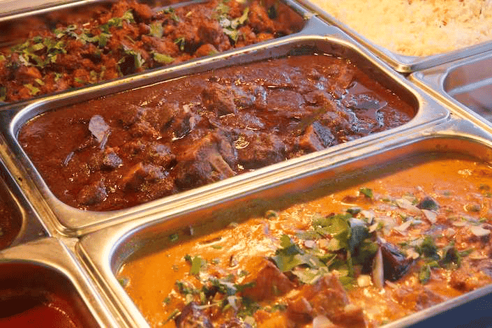 A selection of savoury Vegetarian Indian dishes ready to pack for pickup or delivery.